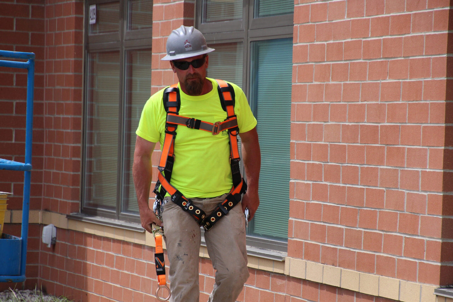 construction worker on site wearing safety harness and helmet|construction site safety topics infographic