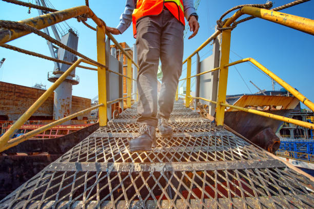 Construction worker walking across walkway