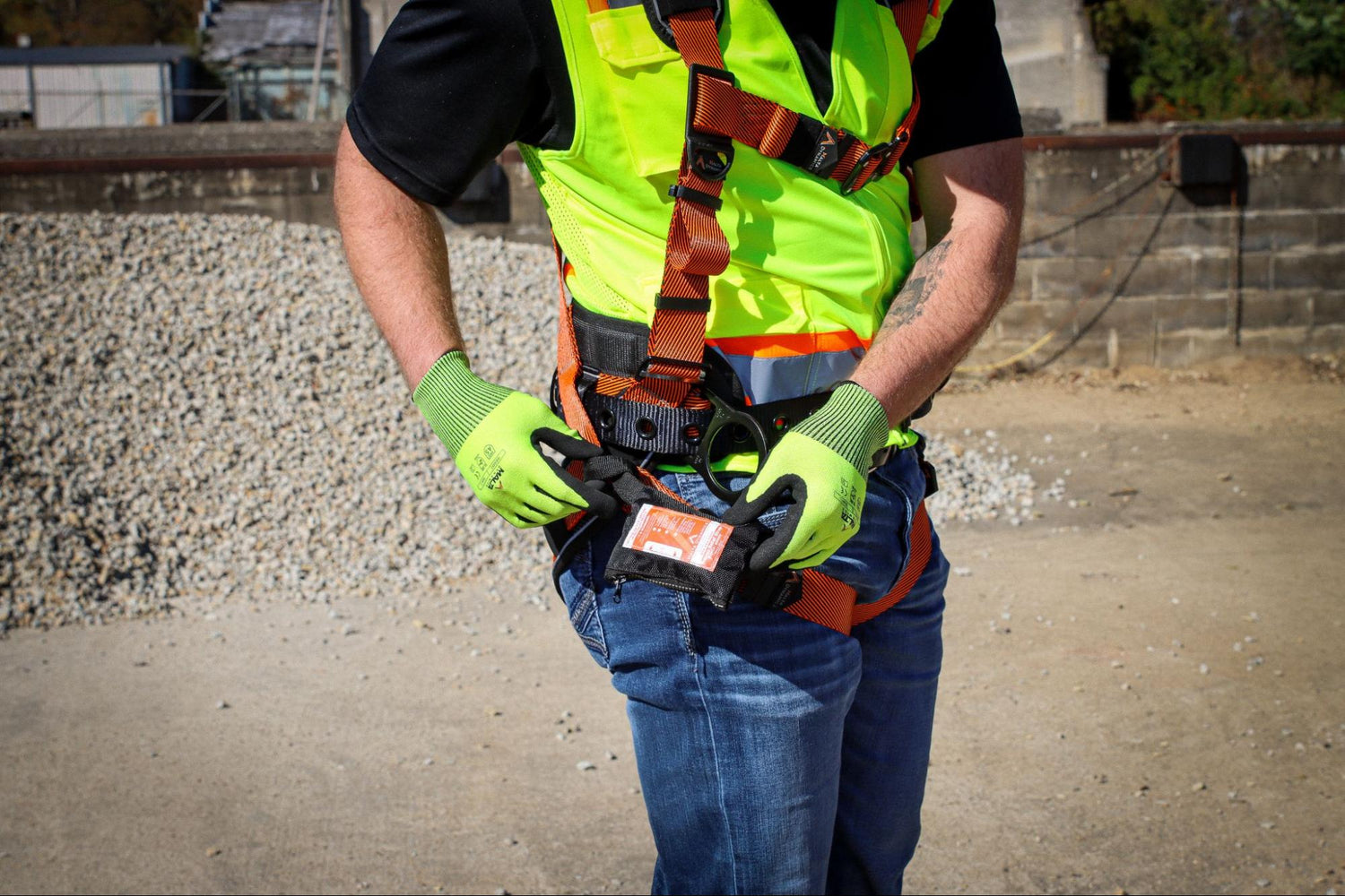 Construction worker tightening harness