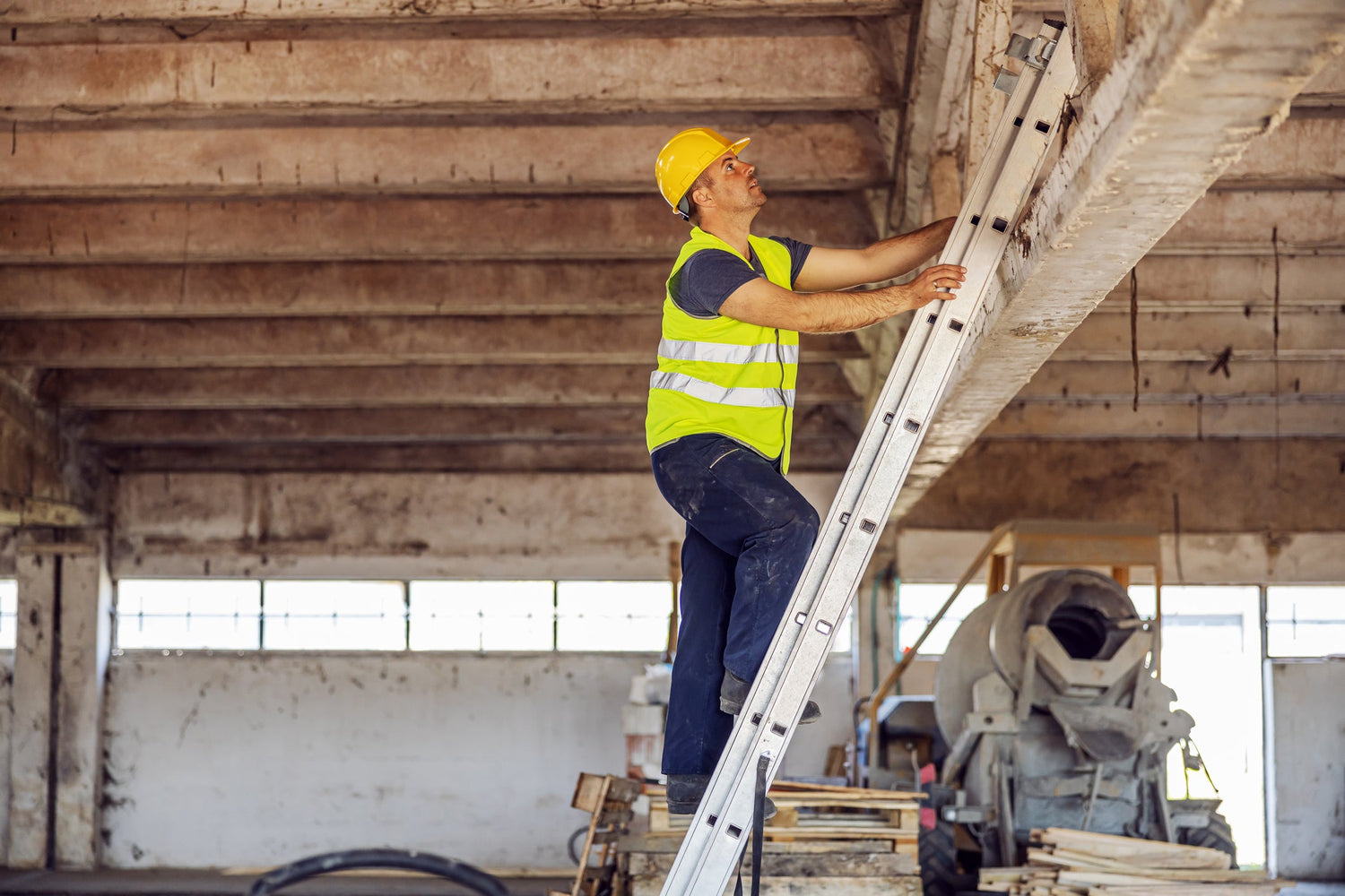 Construction site builder climbing on ladder