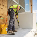 Man working on construction site wearing Malta Dynamics PPE.