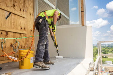 Man working on construction site wearing Malta Dynamics PPE.