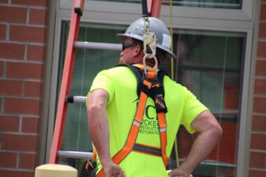 man on a ladder using protective equipment